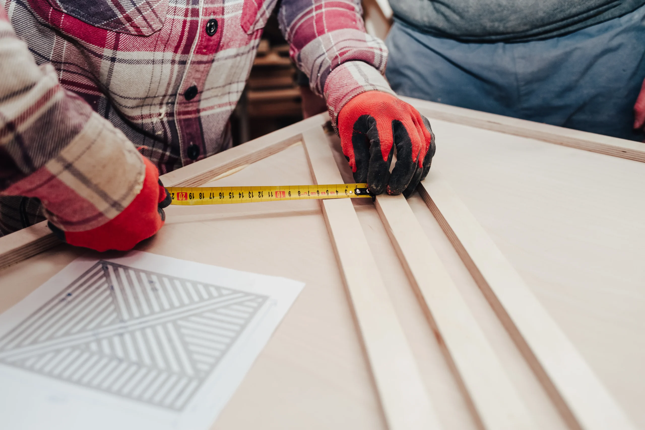 carpenter-measures-plywood-boards-2026-01-05-23-01-09-utc